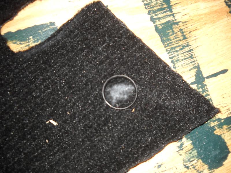Spriked ring fastners 01.JPG - The ring fastners for the Moss Carpet kits is a bit different than the lift the dot fastners on my Amco kit. Here, the spot for the fastner is marked with chalk, and the fastner is pounded through the carpet using a wood backing.